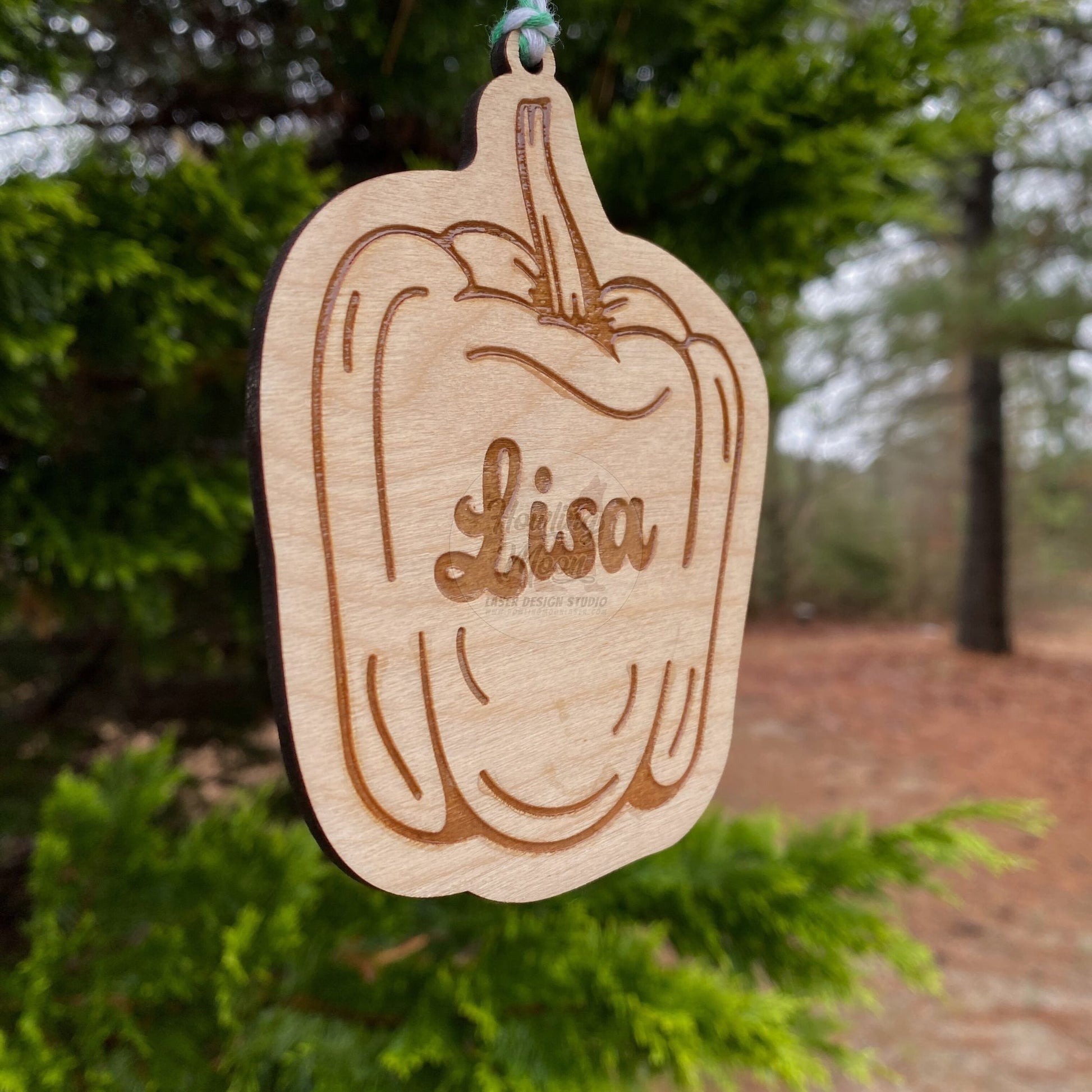 Side view of Personalized bell pepper ornaments handcrafted from natural wood made in Virginia USA by Howling Moon Laser Design Studio.