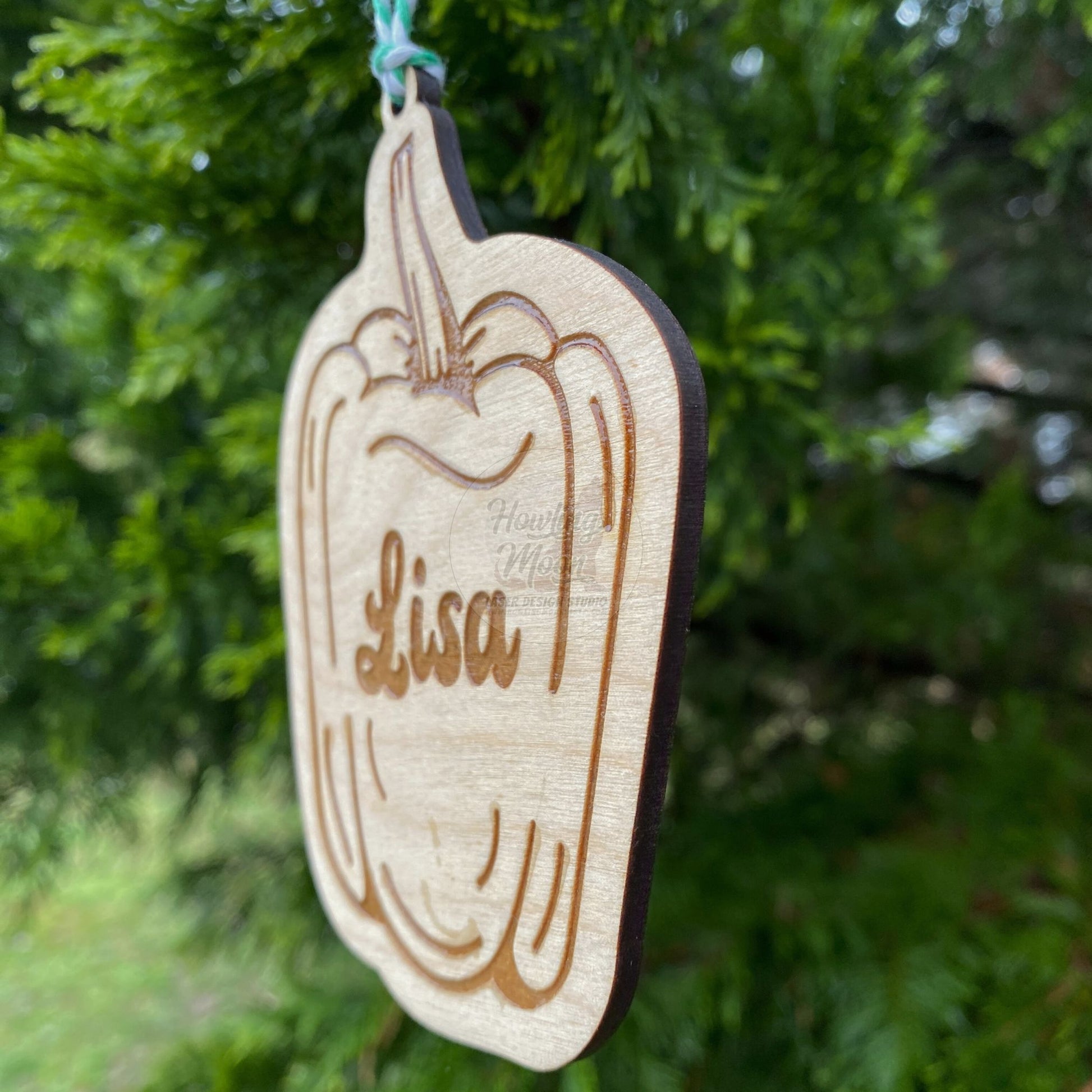 Right side view of Personalized bell pepper ornaments handcrafted from natural wood made in Virginia USA by Howling Moon Laser Design Studio.