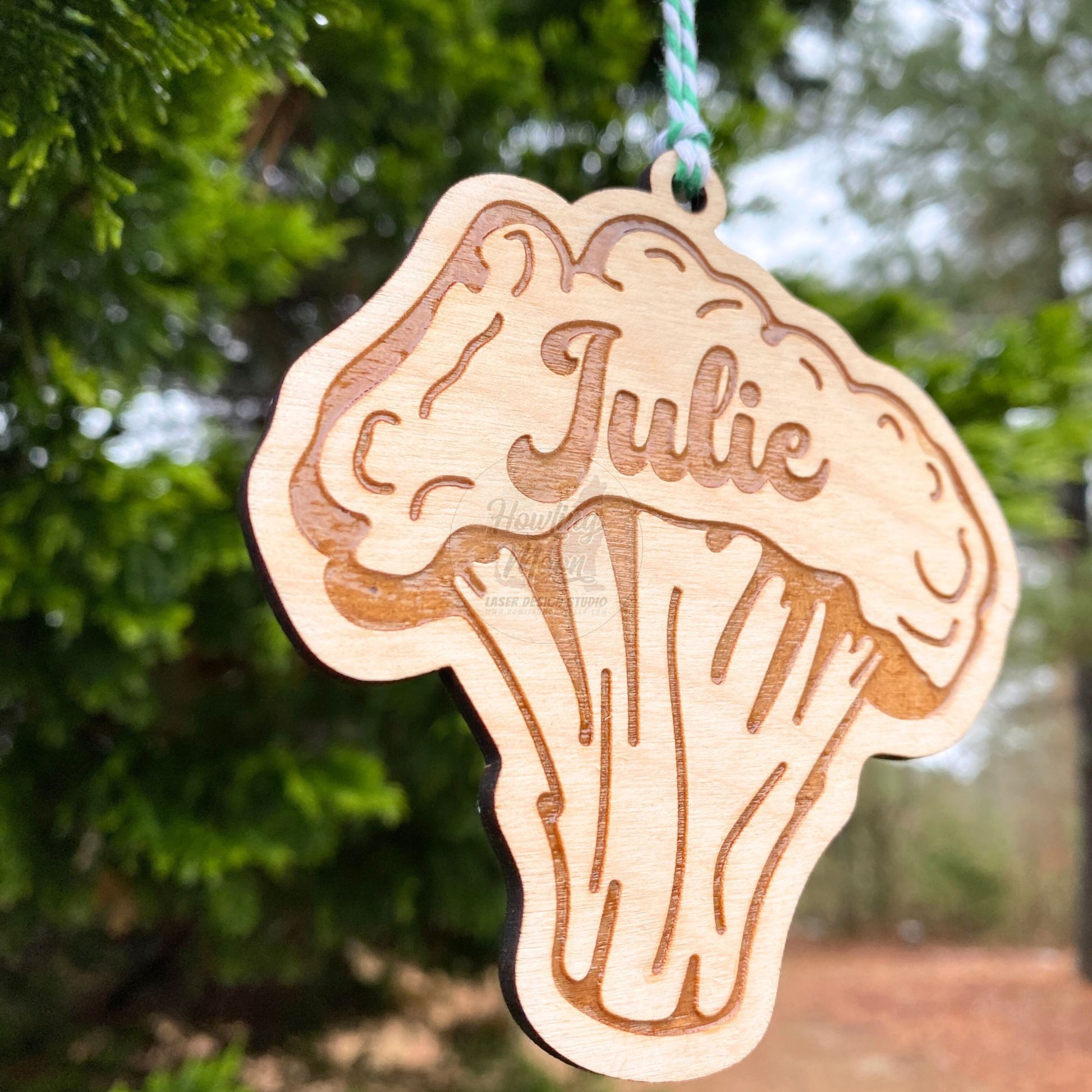 Left side view of Personalized broccoli ornament made of natural wood hanging from a tree - made by Howling Moon Laser Design Studio in Virginia, USA