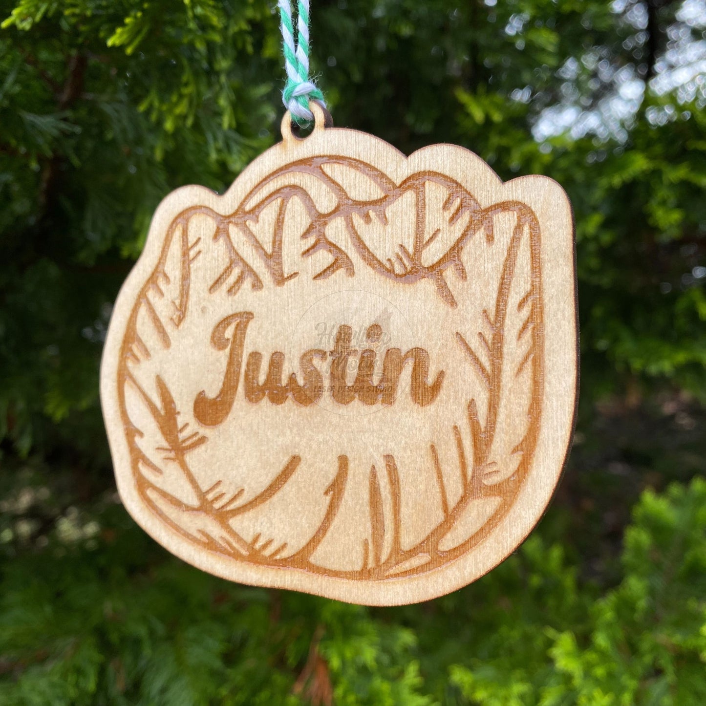 Close up of Personalized cabbage ornament hanging from a tree with green & white twine. Made by Howling Moon Laser Design in Virginia, USA