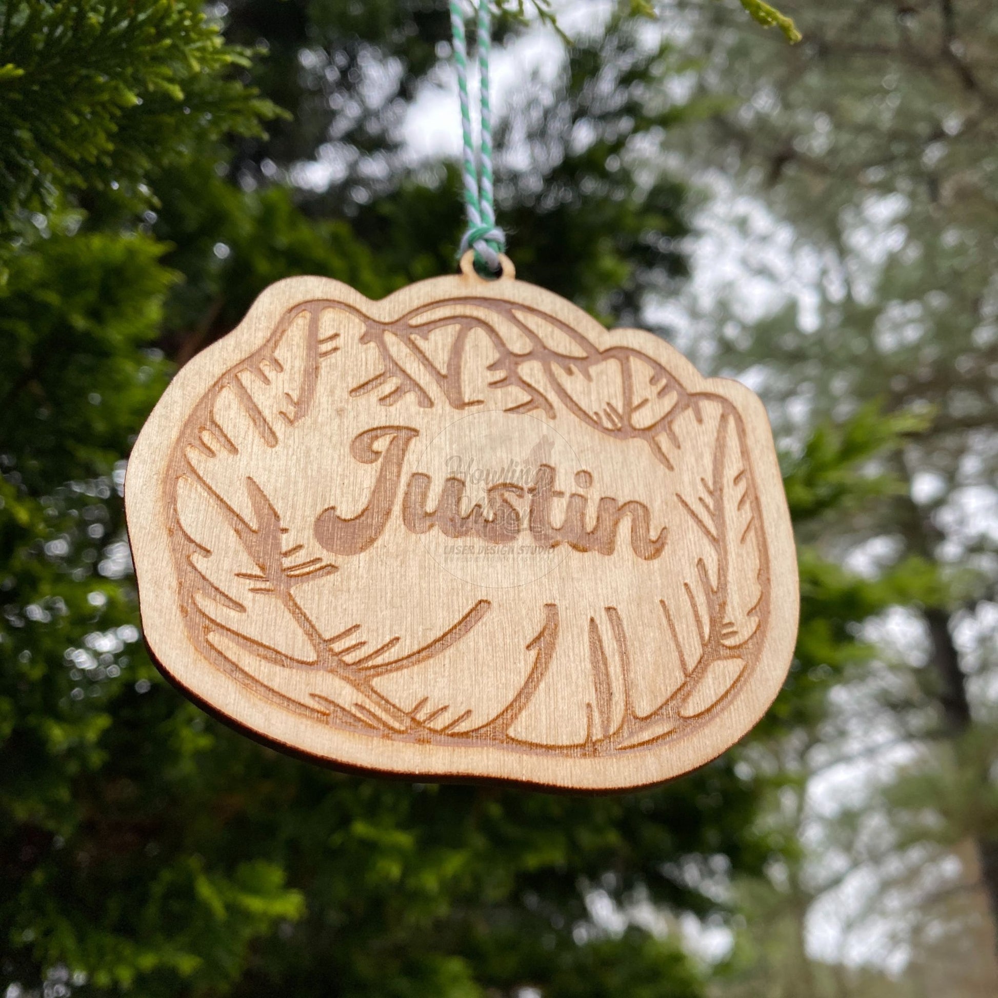 Close up of Personalized cabbage ornament hanging from a tree with green & white twine. Made by Howling Moon Laser Design in Virginia, USA