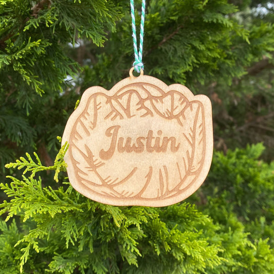 Personalized cabbage ornament hanging from a tree with green & white twine. Made by Howling Moon Laser Design in Virginia, USA