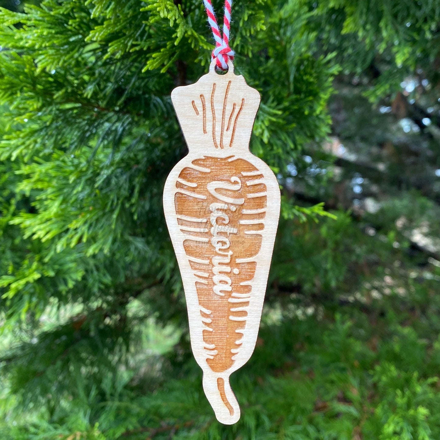 Carrot ornament hanging from tree - made by Howling Moon Laser Design in Virginia, USA