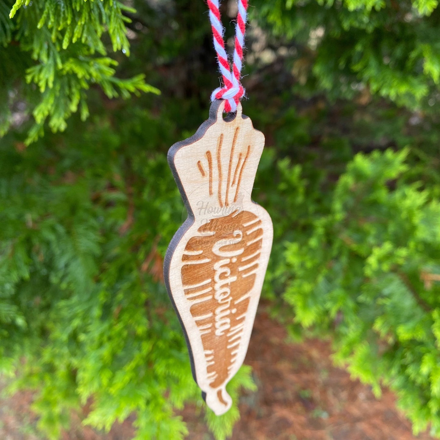 Side view of Carrot ornament hanging from tree - made by Howling Moon Laser Design in Virginia, USA