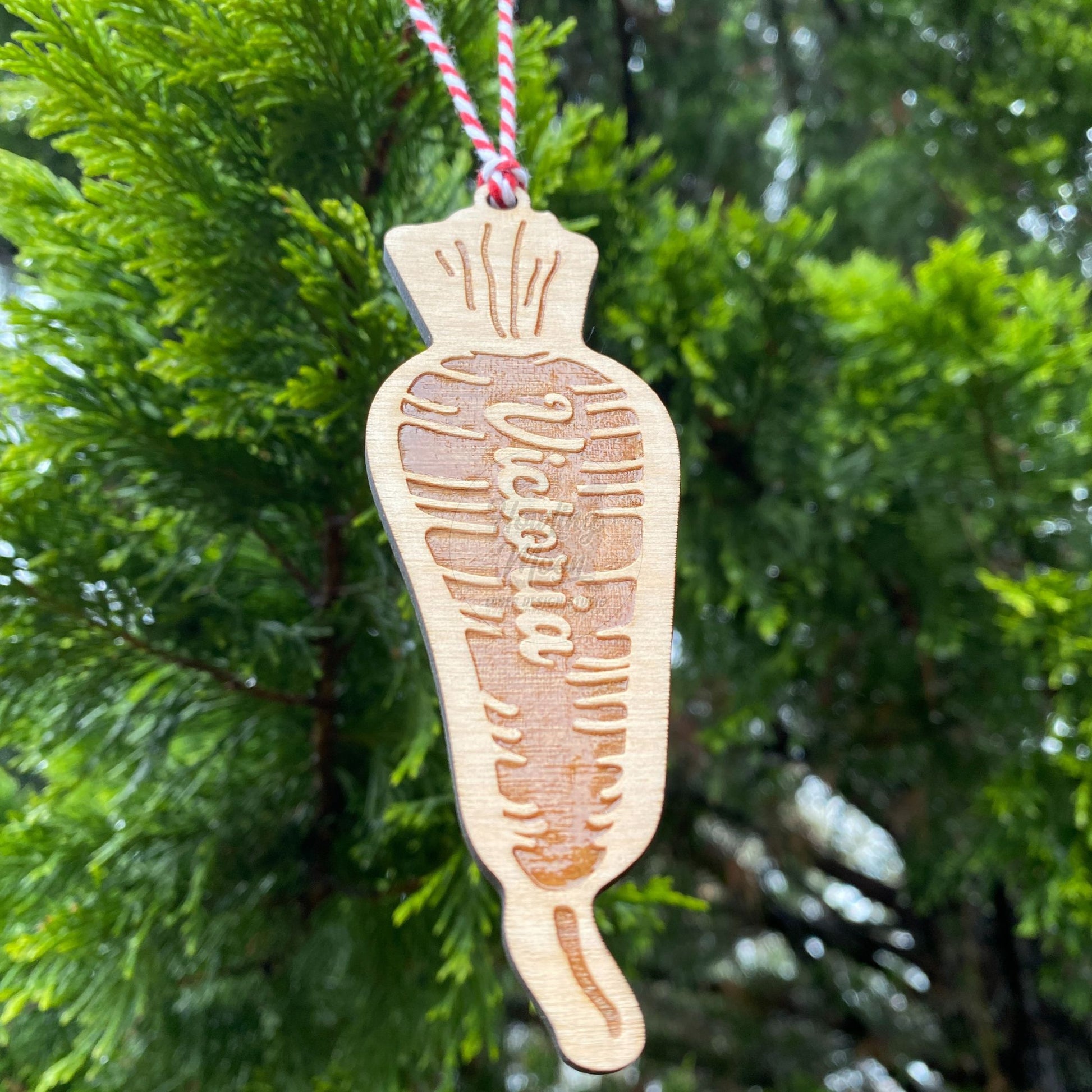Close up of Carrot ornament hanging from tree - made by Howling Moon Laser Design in Virginia, USA