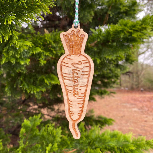 Personalized carrot ornament from Howling Moon Laser Design in Virginia USA - garden tag is shown here hanging from a coniferous tree