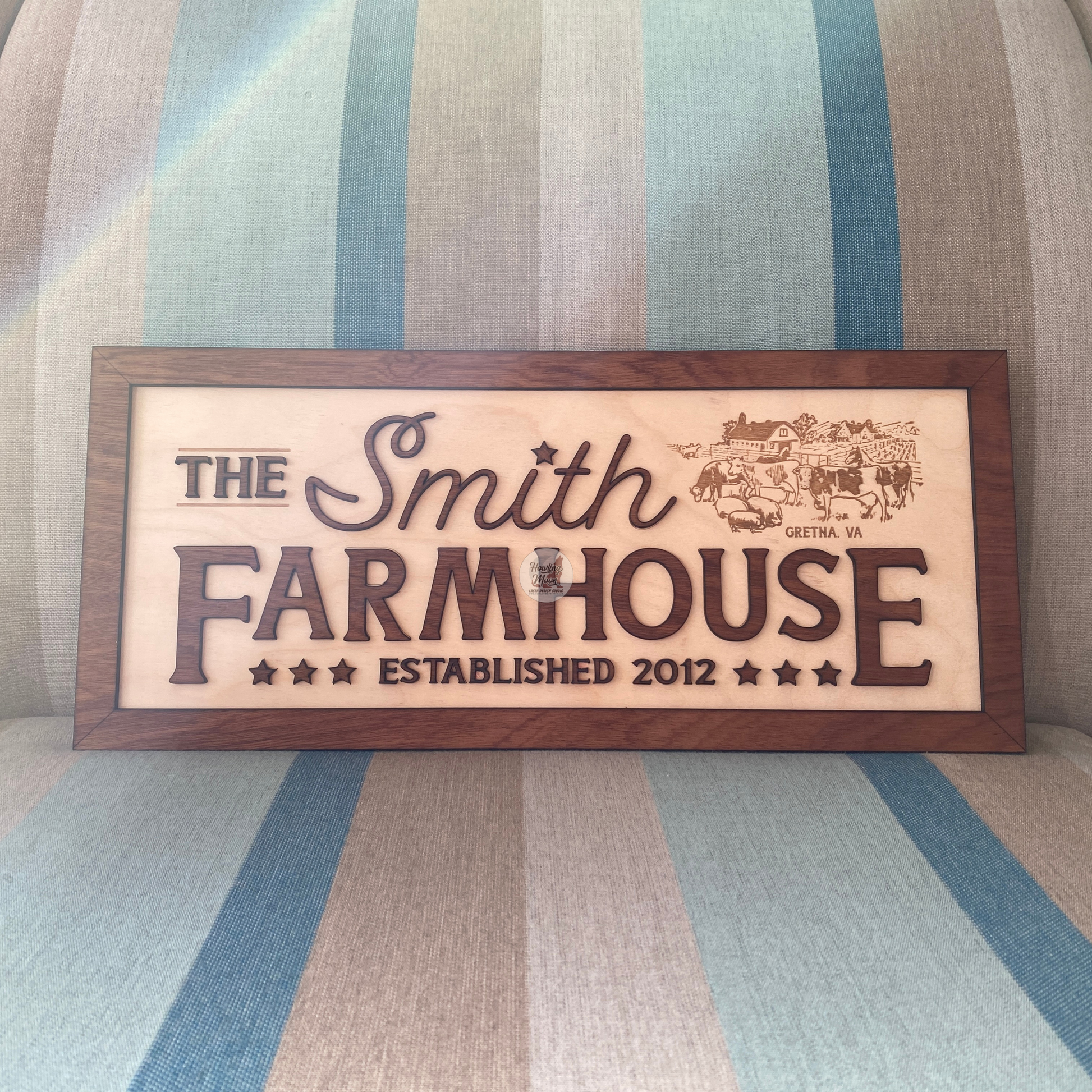 Family Farmhouse Sign from Howling Moon Laser Design sitting on a chair in the sun
