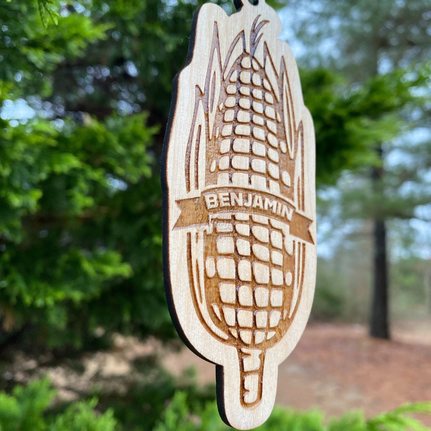 Side view of Personalized Sweet Corn Ornament from Howling Moon Laser Design features hand drawn ear of corn and twine ribbon for hanging